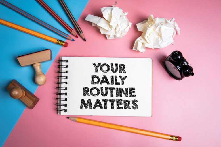 A notebook displaying "Your Daily Routine Matters" surrounded by office supplies, highlighting a daily routine for mental health.