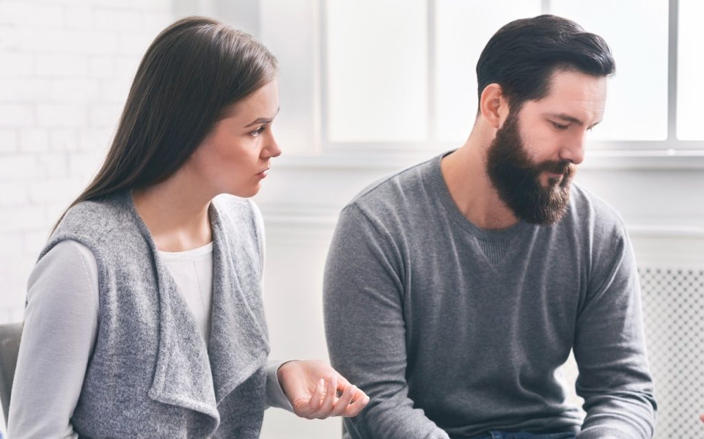 Two people discussing guilt vs shame in recovery during a supportive therapy session at River's Bend.